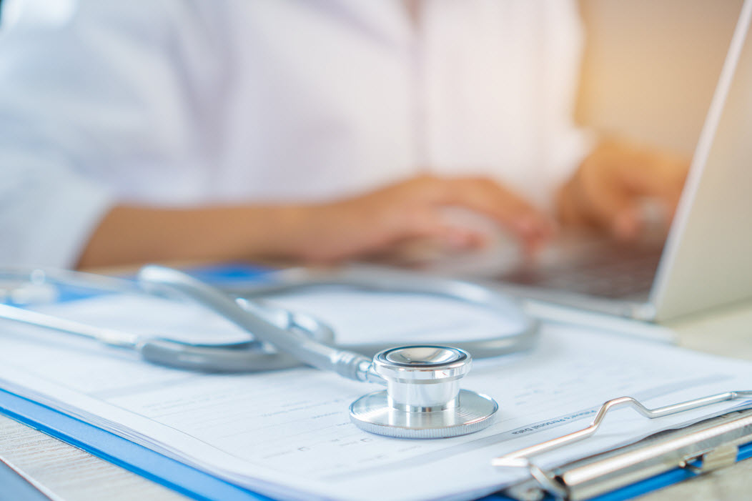 Provider typing on laptop