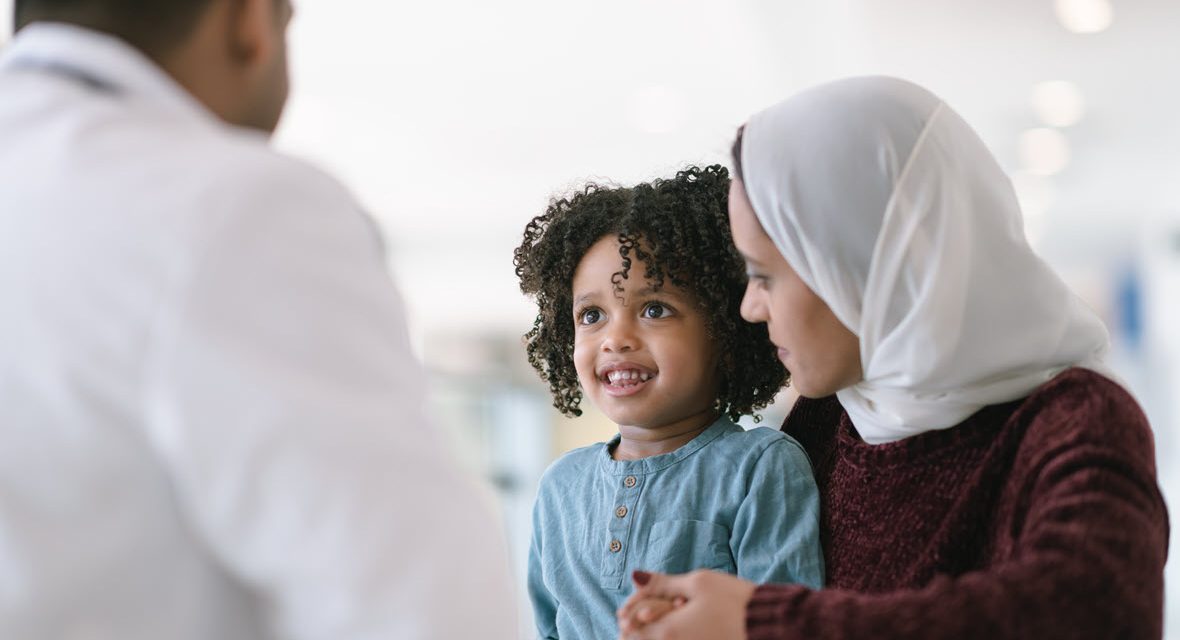 Woman with head cover holding child