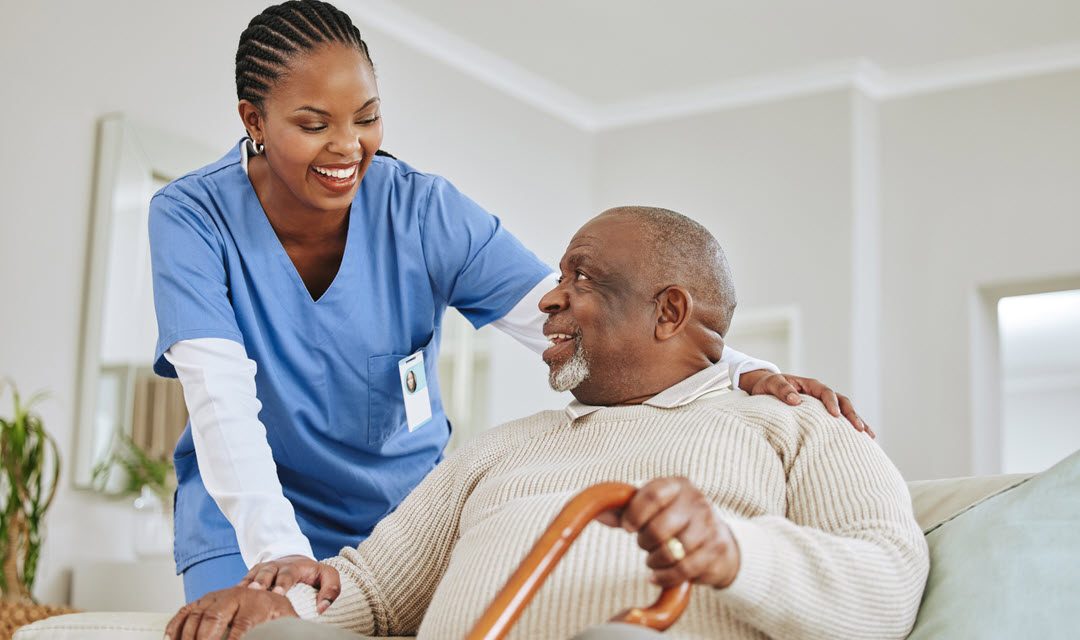 Senior man and female care giver smiling