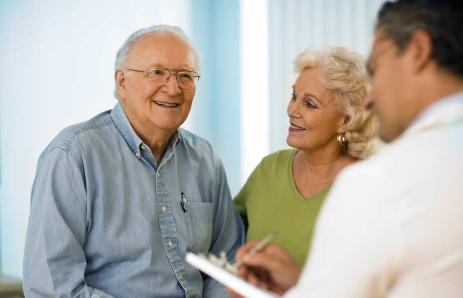 Senior couple smiling at a doctor