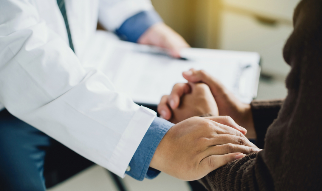 Provider holding the arm of a patient in a comforting way